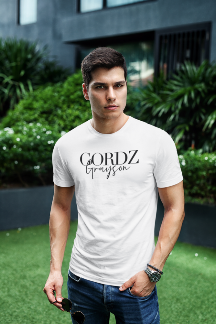 t shirt mockup featuring a stylish man posing at a city garden 433 el 50
