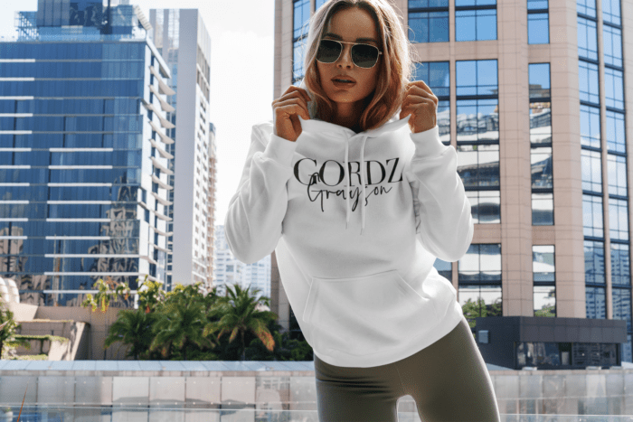 hoodie mockup featuring a woman posing and some buildings in the background 3550 el1